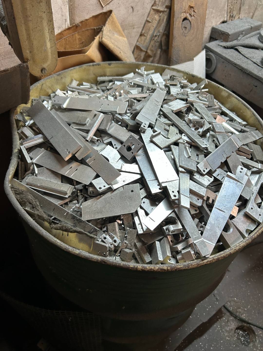 Drum of cut aluminum parts and drops