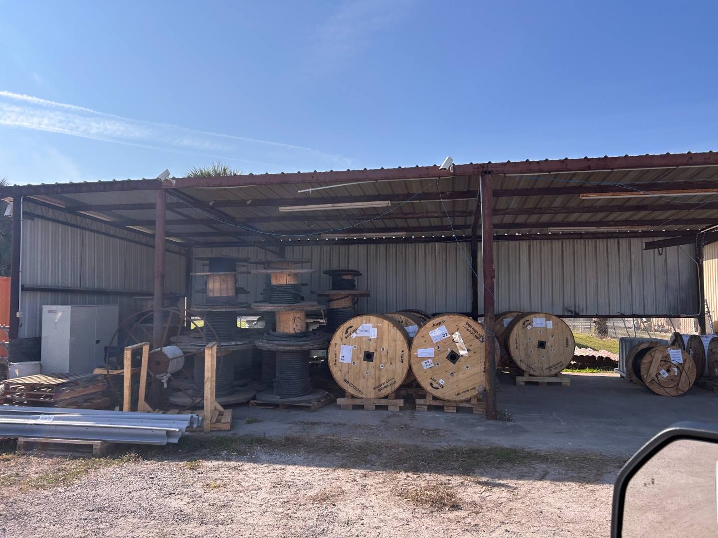 Cable reels and spools stored under a covered equipment yard