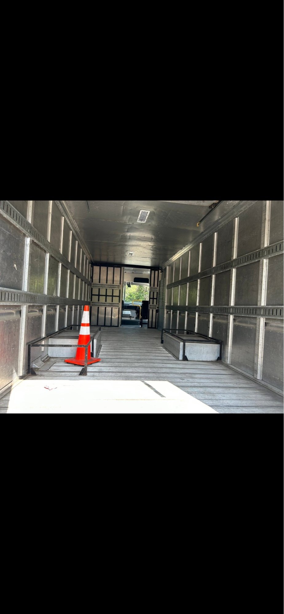 Empty aluminum interior of a Utilimaster step van body