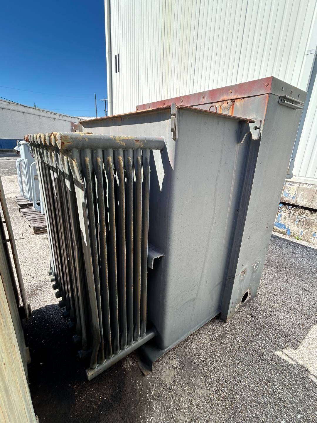 Gray power transformer with radiator panels