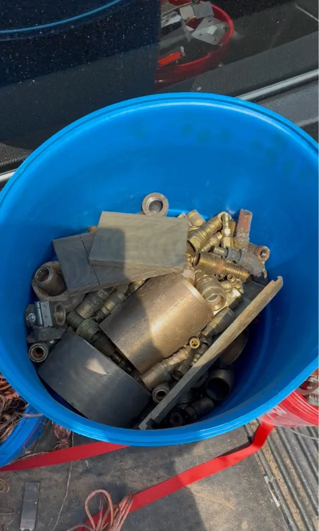 Bucket of brass fittings and mixed metal parts