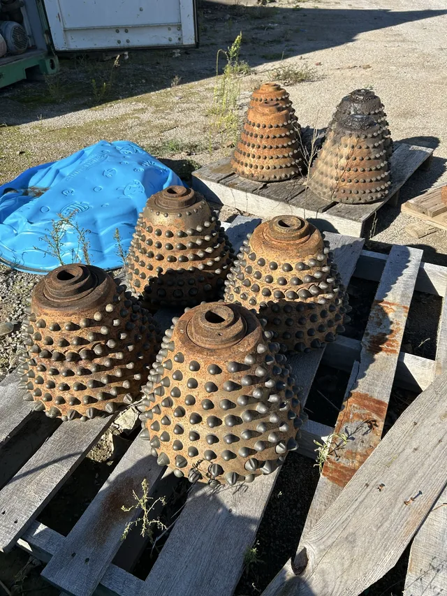 Used conical rock cutters on a pallet