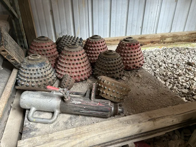 Used roller-cone cutters and drilling components on a shelf