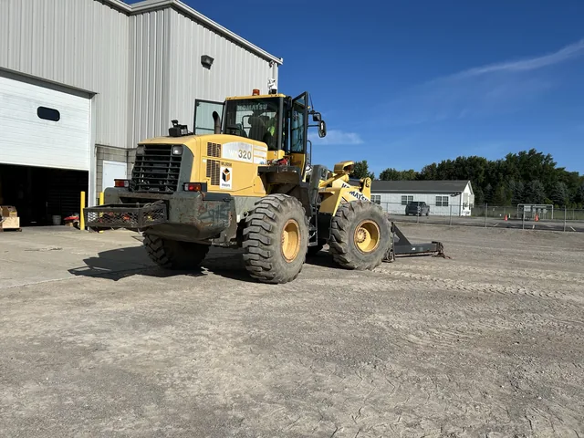 Yellow wheel loader outside the equipment shop