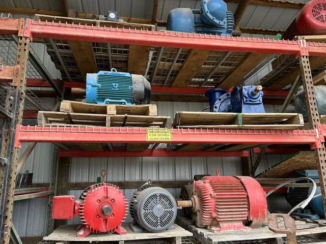 Assorted electric motors on warehouse shelving