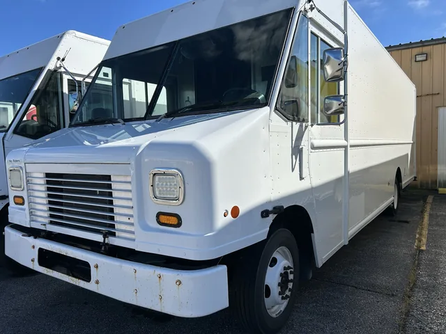 White step van parked outside a commercial building