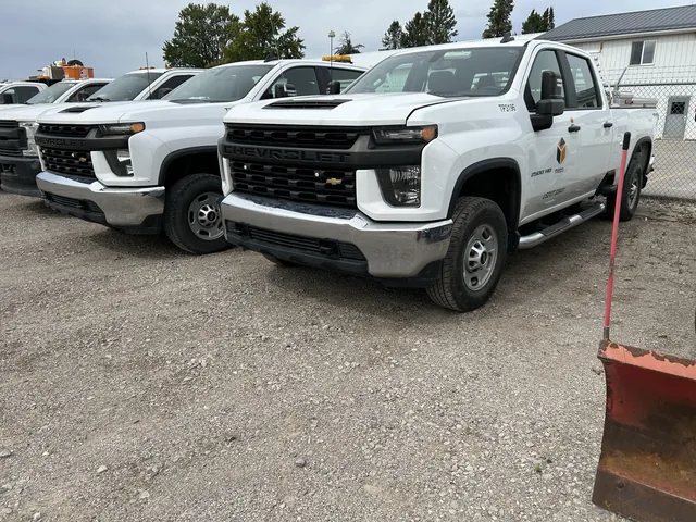 Chevrolet work pickups parked in a fleet row
