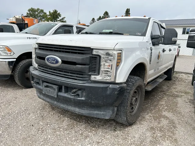 Ford crew-cab work truck in a fleet lineup